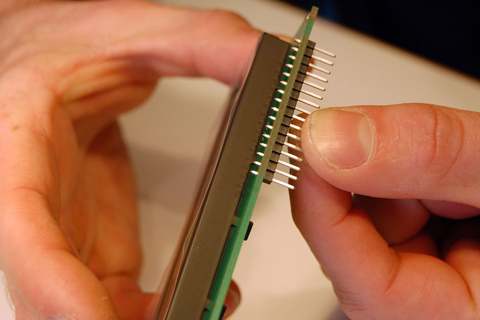 Insert the 16p male header from the bottom and again solder the middle pin first. Then check alignment.