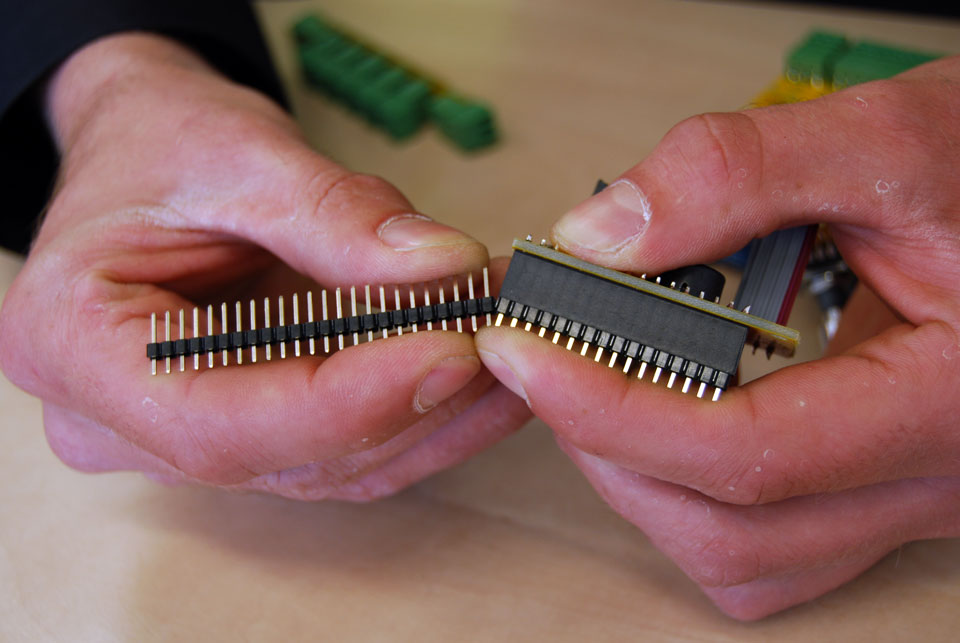 You got a 40pin header with the kit, so you will have to break off 16 pins. A reliable way of doing this is inserting the connector in the female header and applying force like in this picture, while keeping pressure on the last pin in the header.