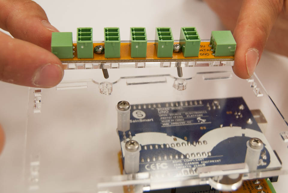 Insert the two bolts through the board, without washers. Mount it to the back panel, with laser cut spacers in between.